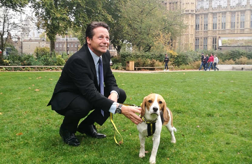Nigel Huddleston with Dogs Trust Puppy outside parliament