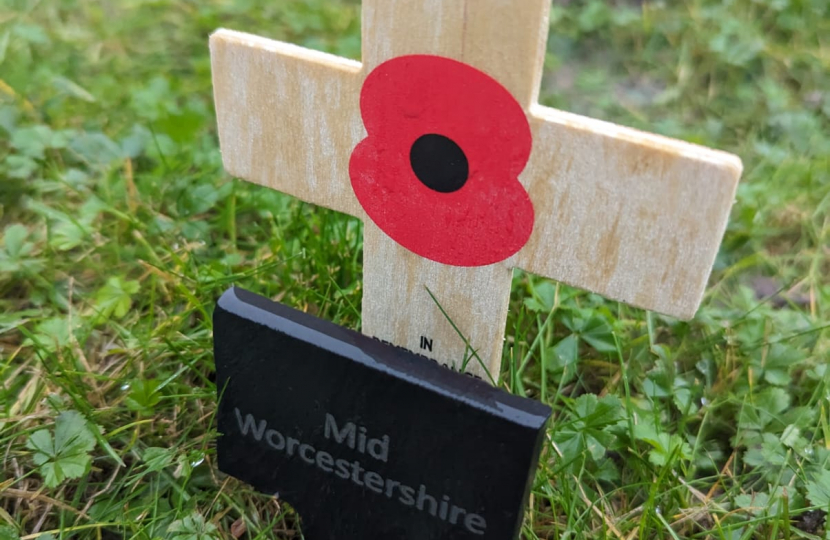 Nigel Huddleston MP plants a cross in the 'Constituency Garden of Remembrance' at the Houses of Parliament.